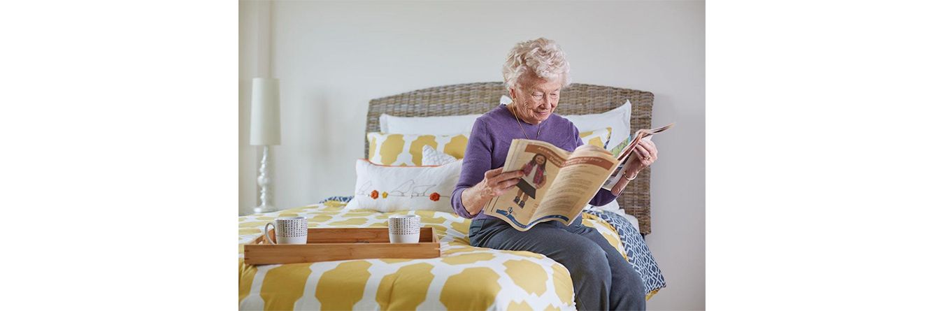 elderly lady reading a newspaper