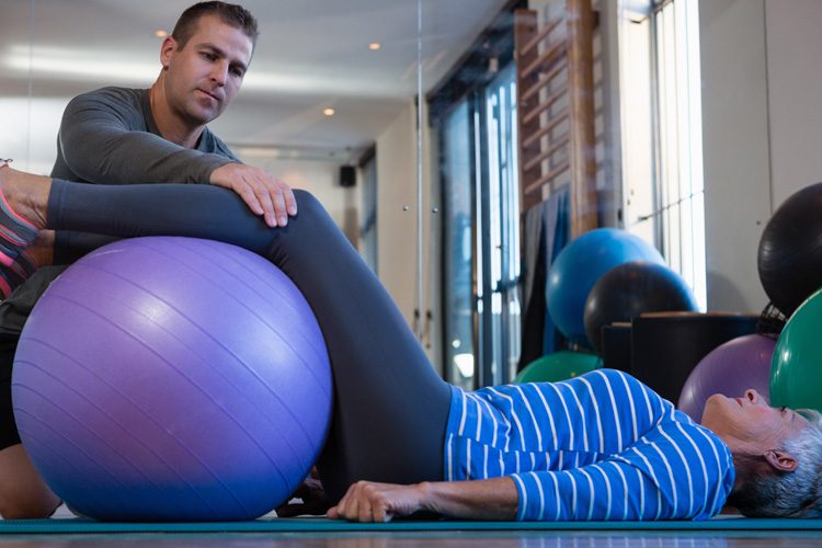 Someren Glen Senior Living Community in Centennial, CO - someren glen caregiver providing physical therapy to senior woman