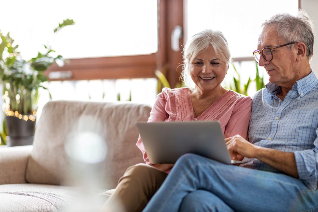 older adult couple looking at laptop screen