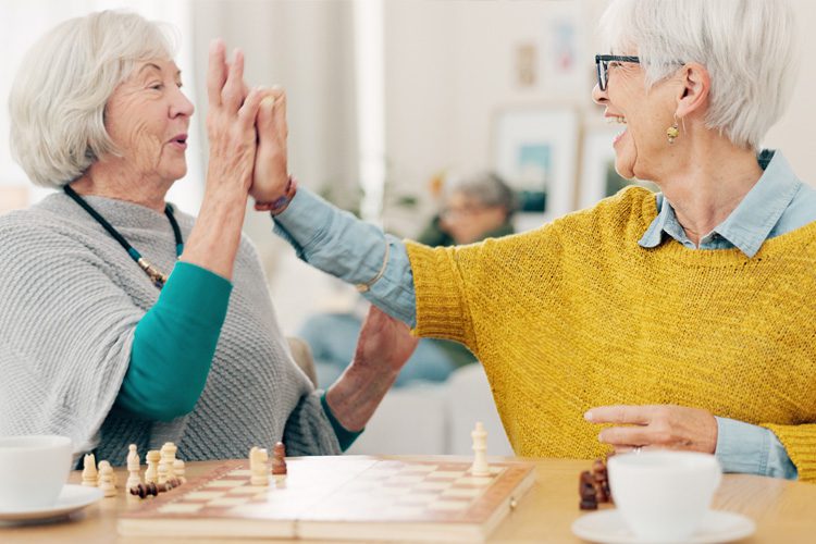 Someren Glen Senior Living Community in Denver, CO - two older women playing chess