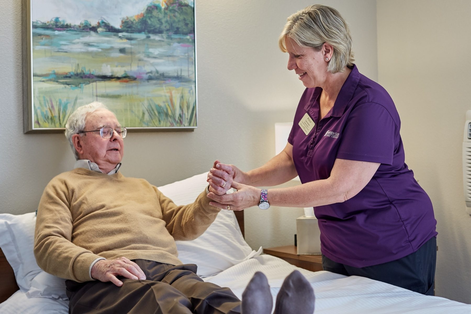 Someren Glen Senior Living Community in Centennial, CO - nurse checking older mans pulse landscape