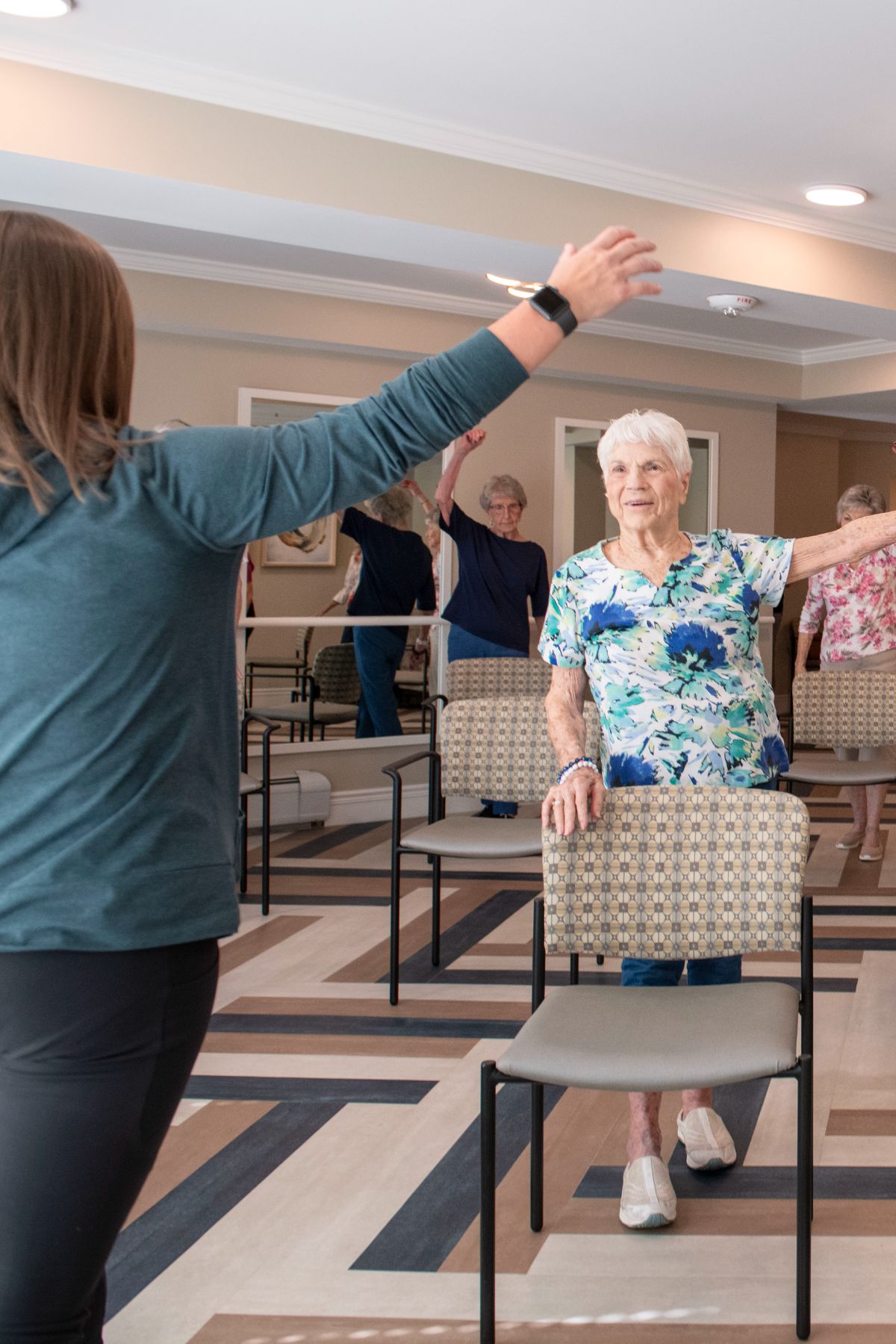 Someren Glen Senior Living Community in Centennial, CO - residents and instructor participating in fitness class portrait