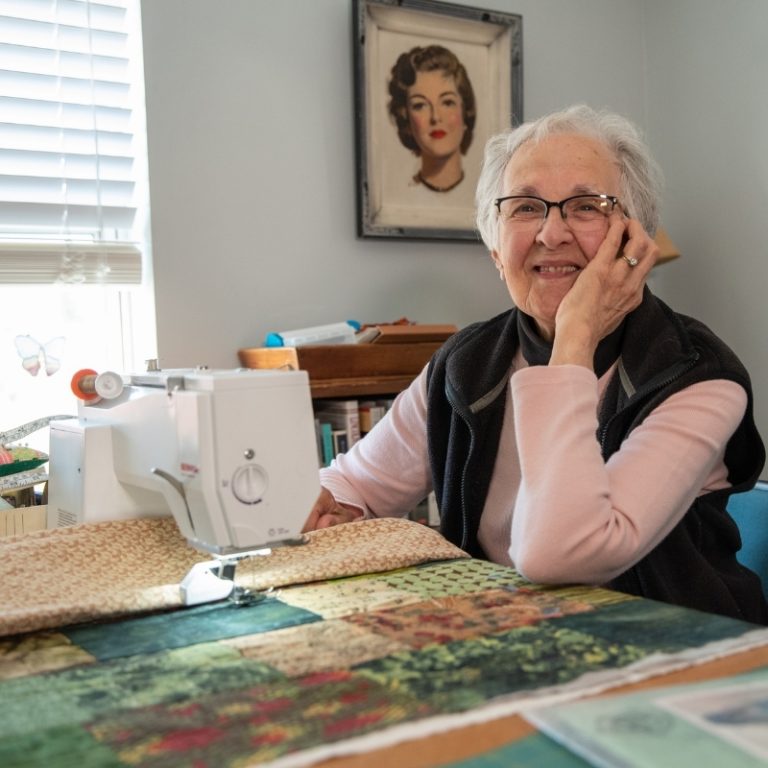 Someren Glen Senior Living Community in Centennial, CO - older woman sewing 25 square