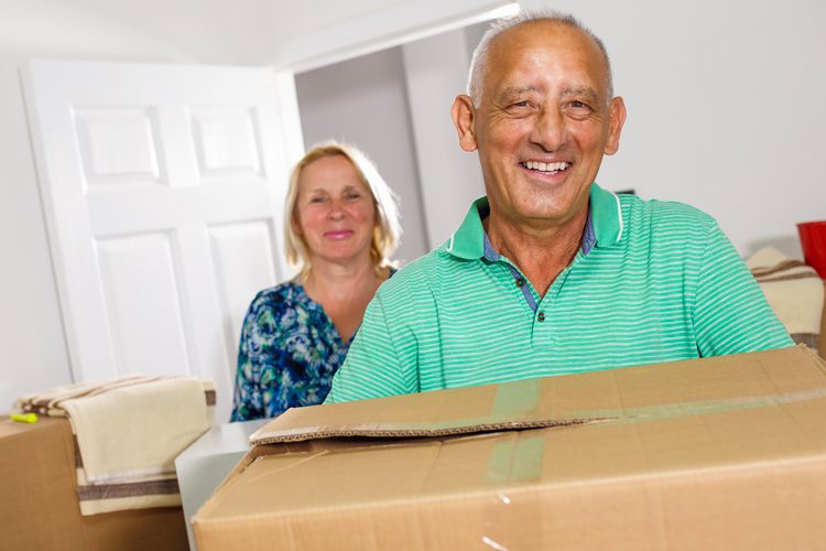 Someren Glen Senior Living Community in Centennial, CO - older couple carrying moving boxes