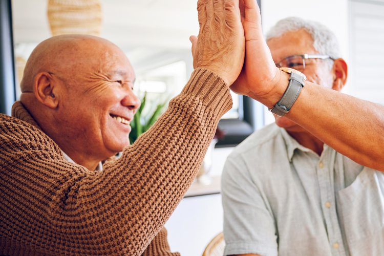 Someren Glen Senior Living Community in Centennial, CO - senior men high fiving