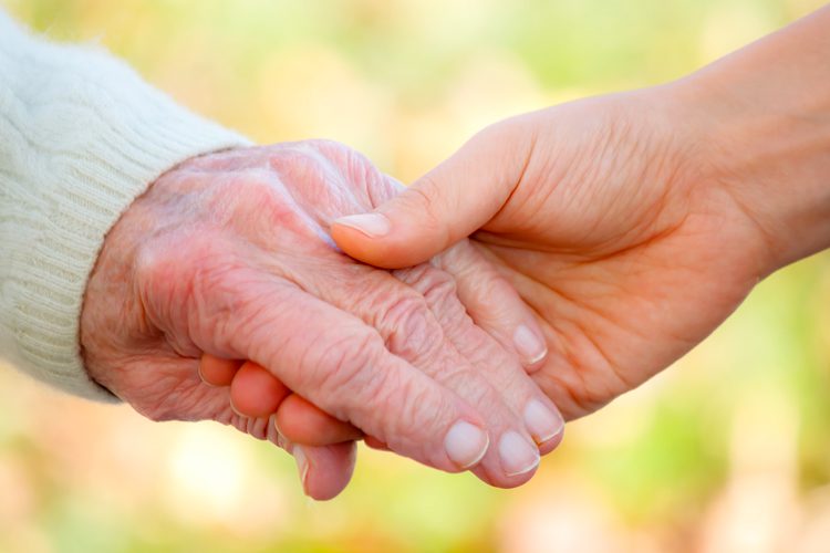 Someren Glen Senior Living Community in Centennial, CO - holding a senior womans hand