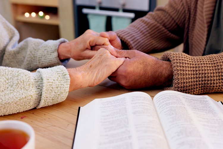 holding hands and bible Someren Glen Senior Living Community in Centennial, CO - holding hands and bible