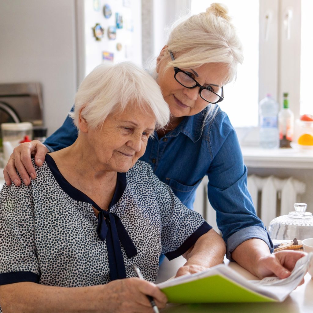 Someren Glen Senior Living Community in Centennial, CO - sg adult woman with senior mother looking a finances