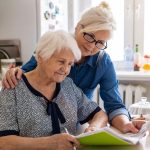 Someren Glen Senior Living Community in Centennial, CO - sg adult woman with senior mother looking a finances